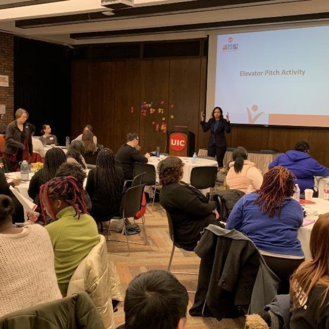 A leader practicing a workplace presentation in front of a supportive cohort